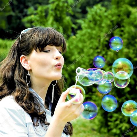 Young Girl Blowing Soap Bubbles — Stock Photo © Vladitto 1420486