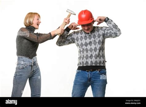 The Wife Screams And Hits Her Husband On The Head With A Hammer The