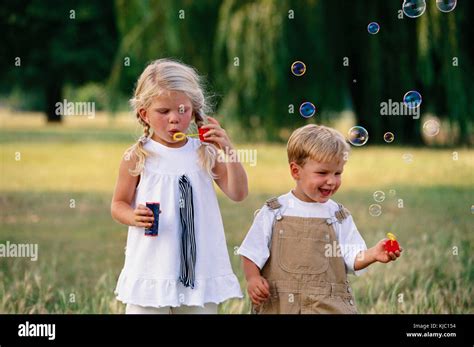 Children Playing With Bubbles Stock Photo Alamy