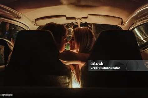 Young Couple Kissing Each Other In Car During Date Stock Photo
