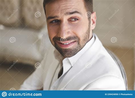 Elegant Young Handsome Man With A Beard In A White Classic Suit The