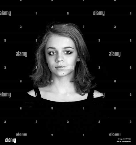 Black And White Portrait Of Beautiful Teenage Caucasian Blond Girl Over Black Background Stock