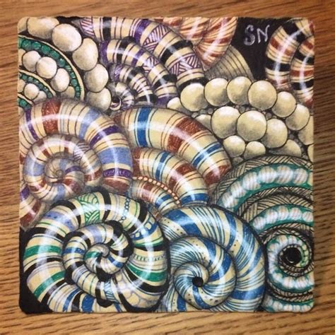 A Square Coaster With An Image Of Spirals And Balls On Its Surface