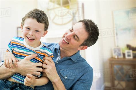 Caucasian Father And Son Playing Together Stock Photo Dissolve