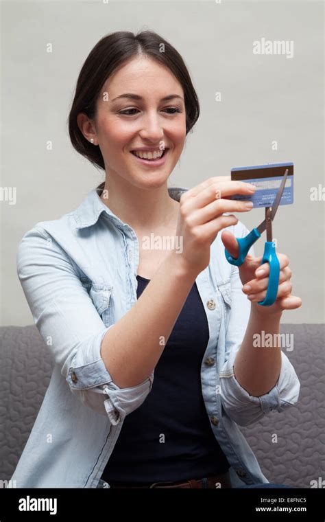 Young Woman Cutting Up Credit Card Stock Photo Alamy