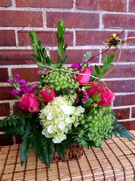 This bouquet features large pink color rose and hydrangea flowers blooming from a green leaf base on a rigid stems tied with lace ribbon. Eckert Florist's Hydrangea and Rose Bouquet in Belleville ...