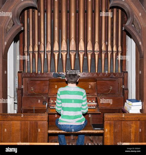 A 14 Year Old Boy Playing A Pipe Organ Inside A Uk Church Stock Photo