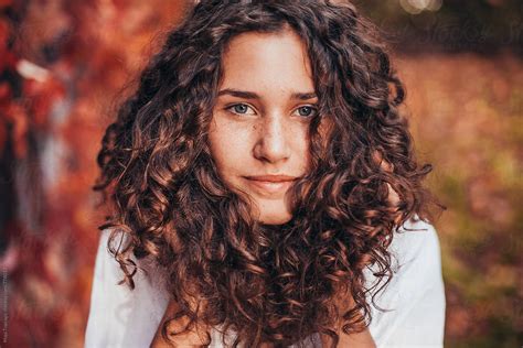 Beautiful Young Woman With Curly Hair Blue Eyes And Freckles By