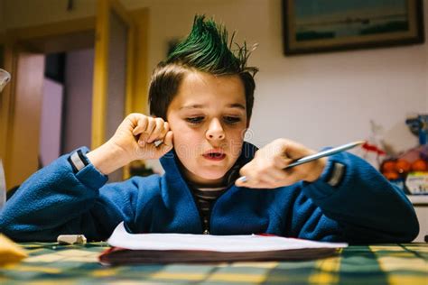 Portrait Of 9 Year Old Boy At Home With Green Colored Hair Crest Stock