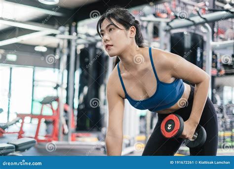 Sporty Young Asian Women Workout Exercise Dumbbell Row Pulling With Dumbbell In The Fitness Gym