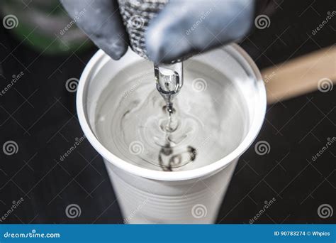 Tattoo Artist Cleaning The Machine Needles On Water Stock Photo Image