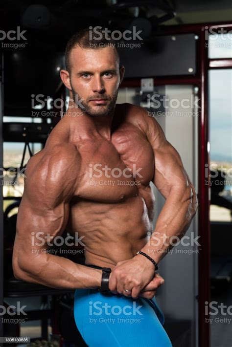 Handsome Muscular Man Flexing Muscles In Gym Stock Photo Download