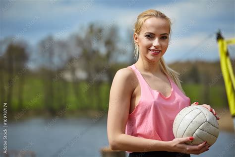 Joyful Sexy Blond Girl Playing Volleyball Outdoors On The Lakesi Stock