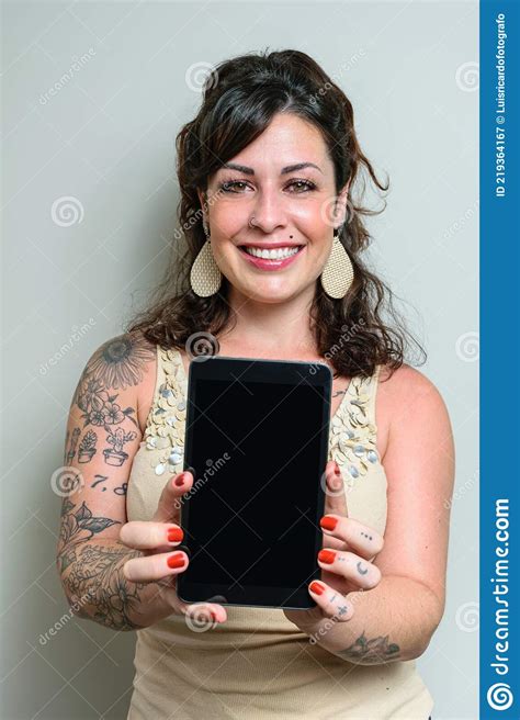 Brazilian Woman Smiling Tattooed And Showing The Tablet To The Camera