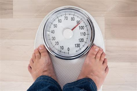 Person Standing On Weighing Scale Stock Photo By ©andreypopov 123278260