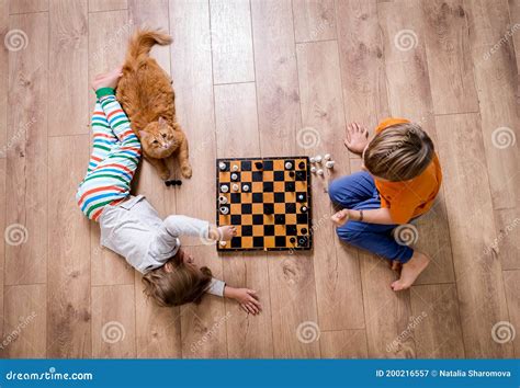Children Playing In Chess Preschool Boy And Girl Play On Floor With