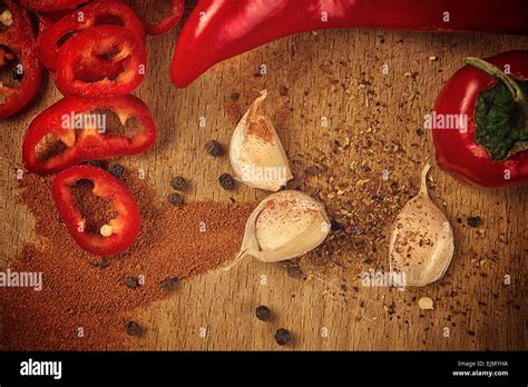 Red Hot Chili Pepper Spice And Organic Garlic On Wooden Kitchen Plate