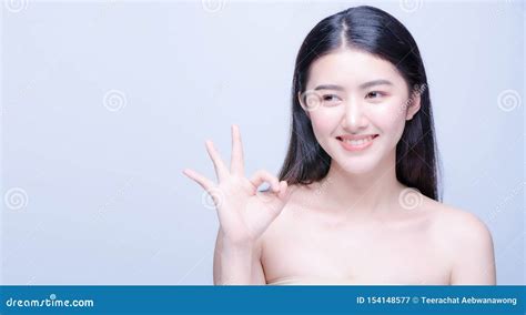 Beauty Portrait Of A Cheerful Attractive Half Naked Asian Woman Showing