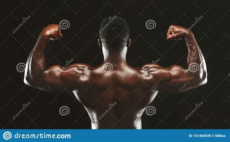 Black Athlete Flexing Muscles Showing Strong Biceps Stock Image