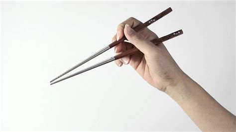 Next, place the second chopstick against your ring finger, holding it with the base of the thumb. How To Hold Chopsticks Correctly - YouTube