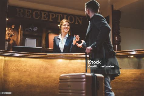 Receptionist Giving Keys To Hotel Guest Stock Photo Download Image