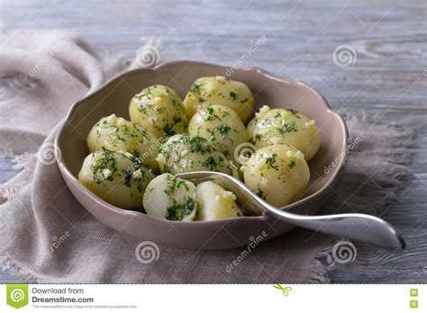 Reduce heat, cover and simmer for about 20 minutes (or until potatoes are tender). Boiled Potatoes With Herb Butter And Garlic Stock Photo ...
