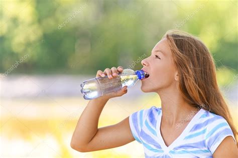 Teenage Girl Drinks Water From Bottle Stock Photo By ©bestphotostudio