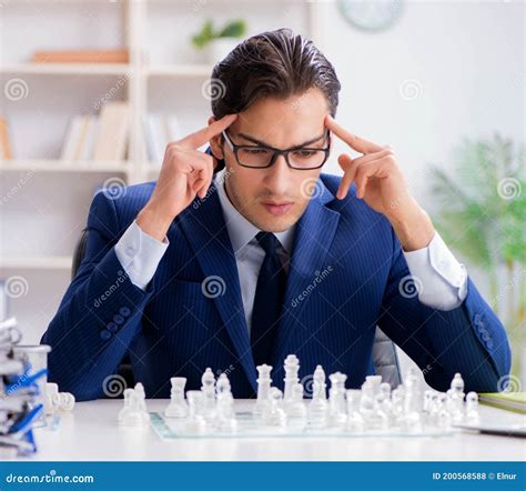 Young Businessman Playing Glass Chess In Office Stock Photo Image Of