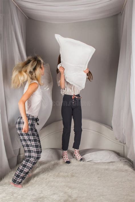 Screaming Mother And Daughter Having Fun And Fighting With Pillows At