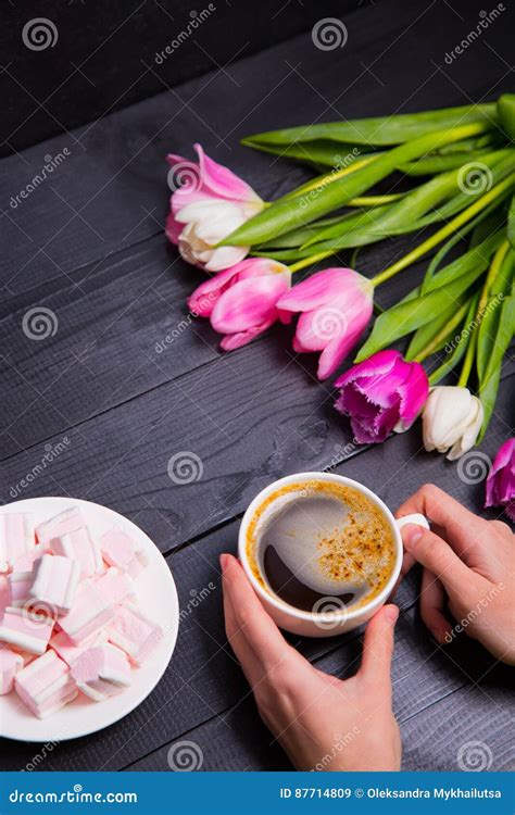 Bouquet Of Tender Pink Tulips And Hands Holding Cup Of Coffee An Stock