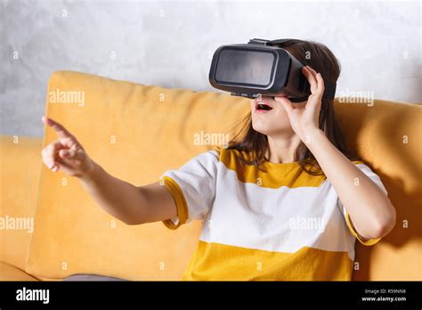 Surprised Long Haired Girl In Pullover Touching Something With Her Hands While Testing Vr