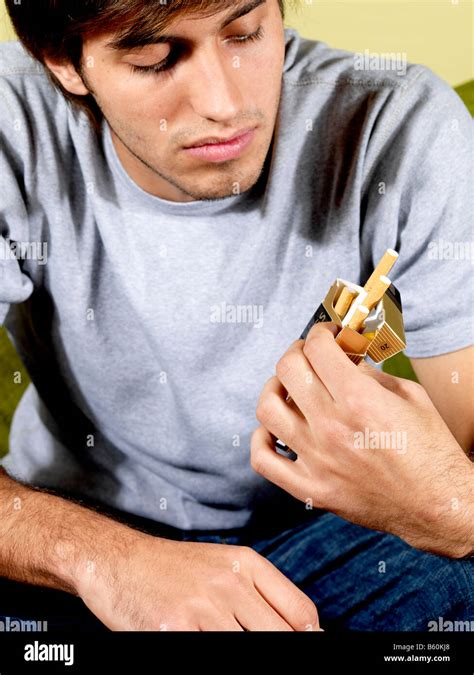 Young Man Holding Cigarettes Model Released Stock Photo Alamy
