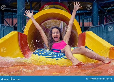 girl in aqua park have fun riding on water slide with inflatable ring stock image image of