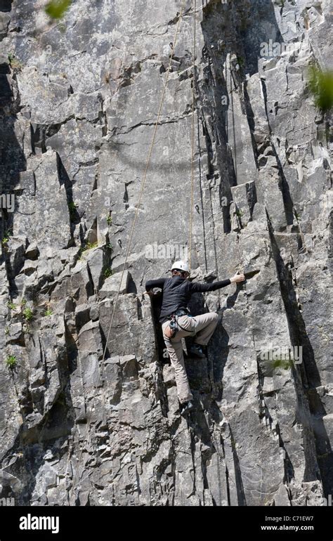 Rope Climbing In The Cheddar Gorge A Climber Works His Way Up The