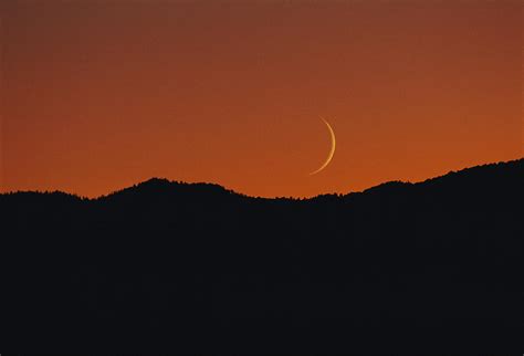 A Crescent Moon Sets Over Mountains Photograph By George F Mobley