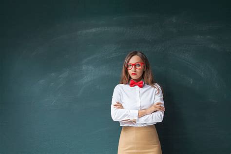 Serious Teacher With Arms Crossed At Blackboard Stock Photos Pictures