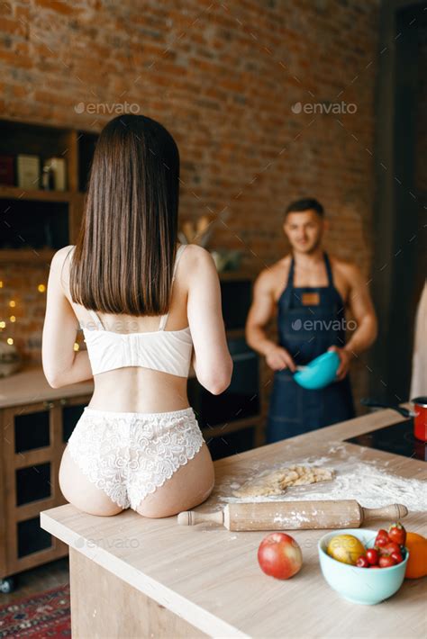 Sexy Couple In Underwear Cooking On The Kitchen Stock Photo By NomadSoul1