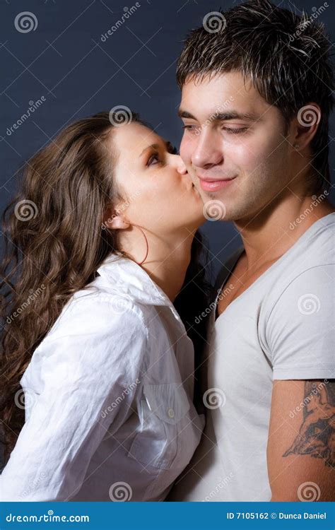 Woman Kissing Man On Cheek Royalty Free Stock Photography