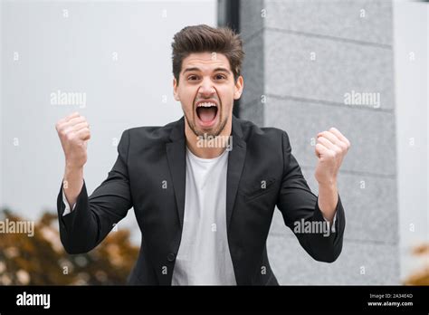 Angry Furious Businessman Having Nervous Breakdown At Work Screaming