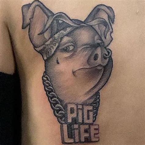 A Man With A Pig Life Tattoo On His Chest