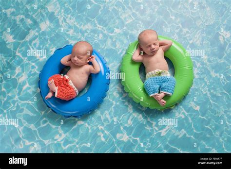 Twin Baby Boys Floating On Swim Rings Stock Photo Alamy