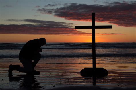 Man Kneeling Cross Stock Photo Download Image Now Beach