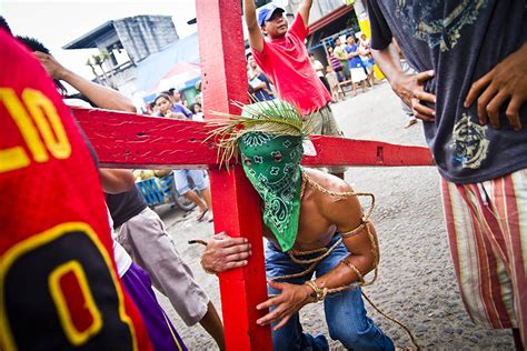 A Celebrant Lifts A Crucufix During Processions In Angeles The