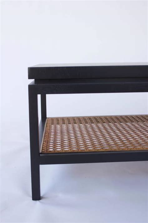 This simple round coffee table has a modern, elegant look and feel, and will complement the furniture in your home. Ebonized Wood and Cane Coffee Table at 1stdibs