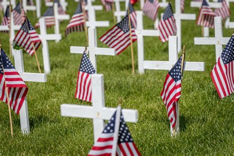 Military Grave Marker Crosses Decorated With American Flags Stock Photo