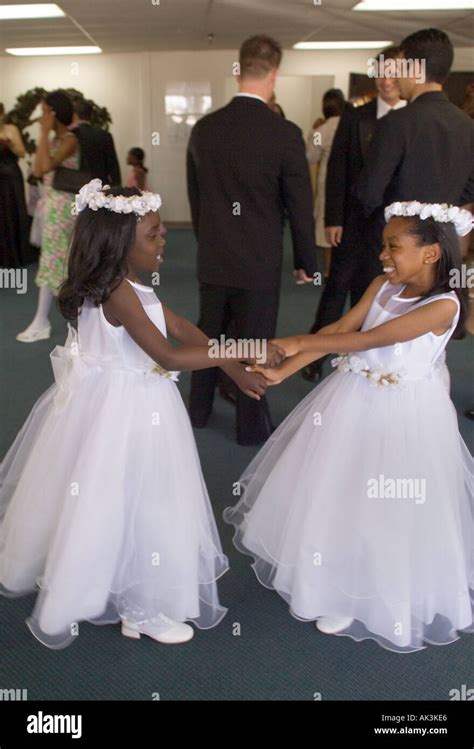 Two African American Flower Girls Play After Participating In An Interracial Wedding In Santa