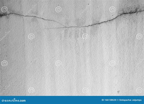 Close Up Of White Cement Crack Wall And Peeled Paint Caused By Water