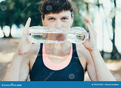 Woman Drinking Water After Exercise In Park Stock Photo Image Of