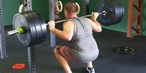here s how to squat with proper form using a barbell
