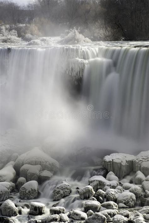 Waterfall Flowing Over Snow Covered Rocks Mist Rising Frost Co Stock